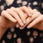 gray-nail-design-female-hand-with-glitter-manicure-min